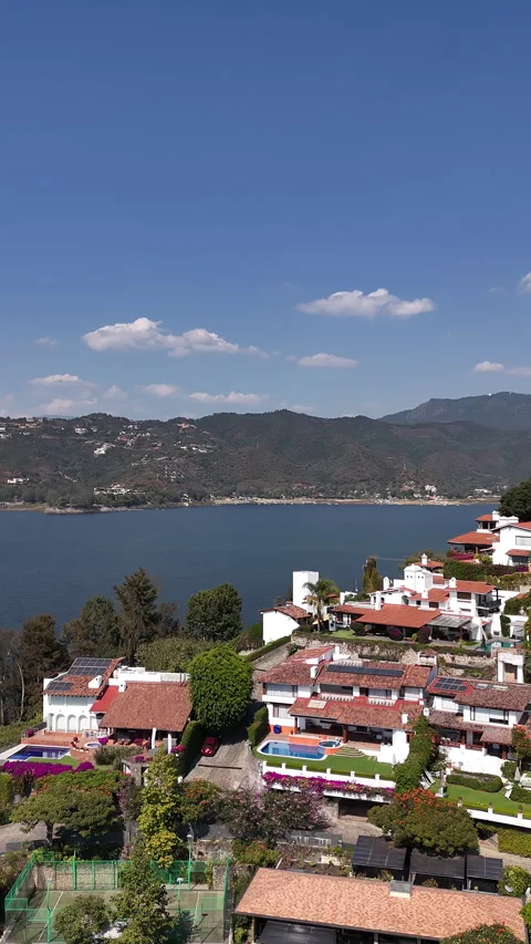 Aerial view of homes in valle de bravo next to the lake Stock Footage 321970231