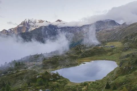 Aerial view of Hopschusee lake with Fletschhorn and Galehorn peaks in mist at Stock Photos