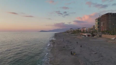 Aerial View: The horizon comes alive with fiery hues as the sun sets over the Video stock 296080098