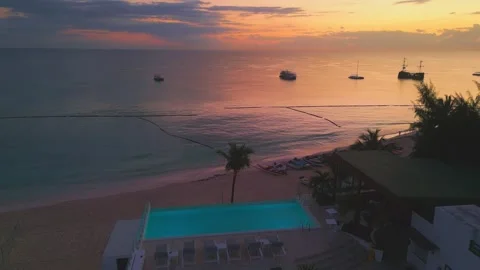 Aerial view of a hotel with a rooftop pool on the beach in Punta Cana at sunrise Stock Footage 305807045