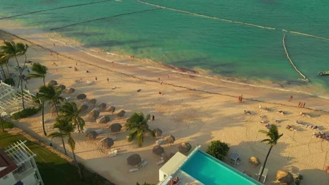 Aerial view of a hotel with a rooftop pool on the beach in Punta Cana Stock Footage 306402945