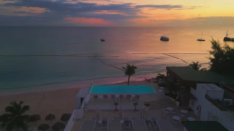 Aerial view of a hotel with a rooftop pool on the beach in Punta Cana at sunrise Video stock 308018109