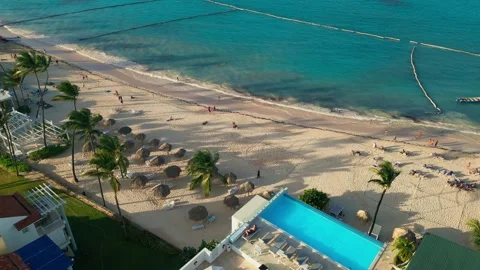 Aerial view of a hotel with a rooftop pool on the beach in Punta Cana Stock Footage 308334256