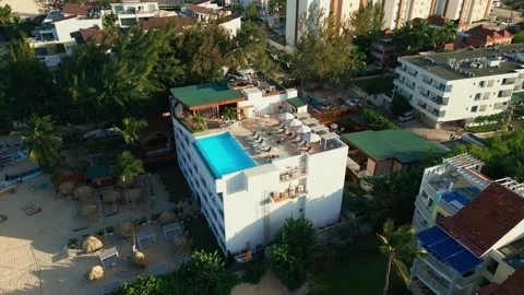 Aerial view of a hotel with a rooftop pool on the beach in Punta Cana Stock Footage 308334280