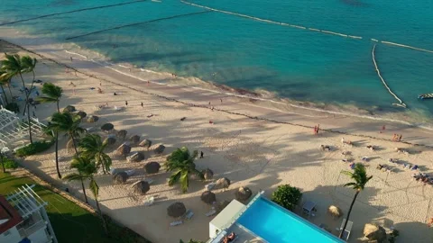 Aerial view of a hotel with a rooftop pool on the beach in Punta Cana Stock-Footage 309945044
