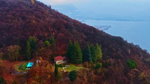 Aerial view of a house and pool on a hillside by Lake Iseo, Italy. Stock Footage 344979808
