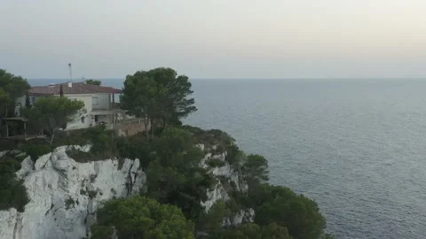 Aerial View Of House On The Edge Of The Cliffs With The Sea In The Background Stock Footage 136559658