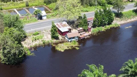 Aerial view of the house, the kitchen area stands above the river Stock Footage 321845716
