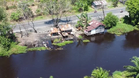 Aerial view of the house, the kitchen area stands above the river Stock Footage 321845984