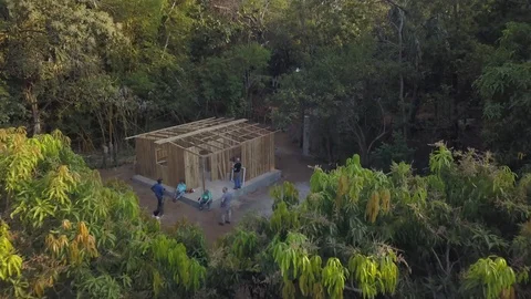 Aerial view of house under construction by volunteers in Guatemalan village Stock Footage 126018391