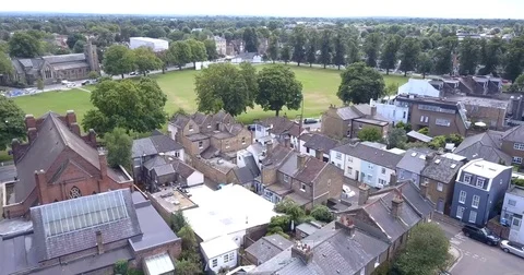 Aerial view of housing &amp; green spaces in affluent London suburb Stock Footage 80296166