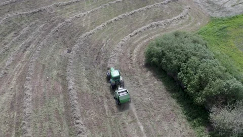 Aerial view how tractor making bales Stock Footage 198799087