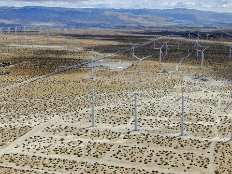 Aerial view of huge array of gigantic wind turbines spreading over the desert in 写真素材
