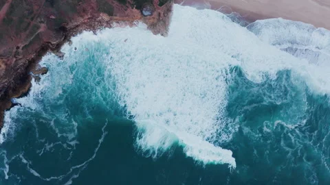 Aerial view of huge Atlantic ocean waves crushinf over cliffs on Praia do Norte Video stock 337497430