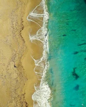 Aerial view of huge beach with waves crashing on the sand Stock Photos