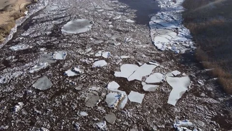 Aerial view of a huge blocks of pack ice going down the river Gauja Stock-Footage 149819212