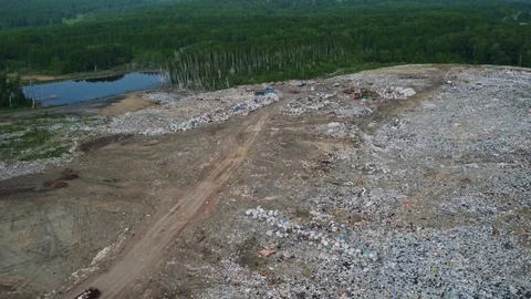 Aerial view of huge city garbage dump at sunset. Wastes of life and production Stock Footage 92862330