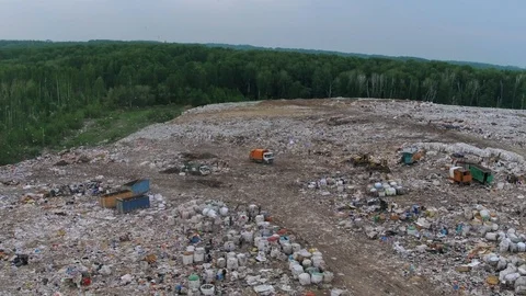 Aerial view of huge city garbage dump at sunset. Garbage truck unloads trash Stock Footage 92886580