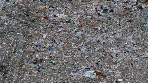 Aerial view of huge city garbage dump at sunset. Garbage men sorting rubbish Stock Footage 92887472