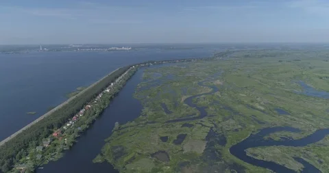 Aerial view. Huge dam. Drone flies over the river, lakes and swamp. 4K Stock Footage 108635550