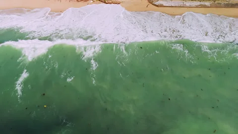 Aerial view of huge hitting waves on sandy beach with white foam Stock Footage 331063139