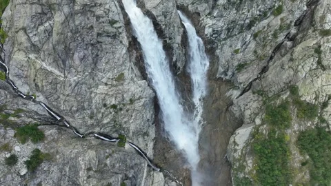 Aerial view of a huge mountain waterfall in the Alps or Caucasus. Stock Footage 275223316