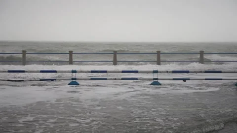 Aerial view of huge waves hitting coastal city seawall during typhoon, storm Stock Footage 340856687