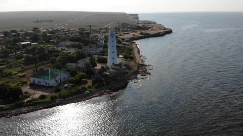 Aerial view huge white lighthouse on coast edge in village Video stock 103183064