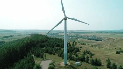 Aerial view of a huge windmill rotating. Clear sunny day. Wind power turbine Stock Footage 220108429