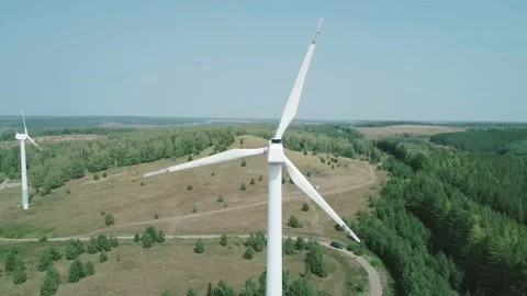 Aerial view of a huge windmill rotating. Clear sunny day. Wind power turbine Stock-Footage 220108997