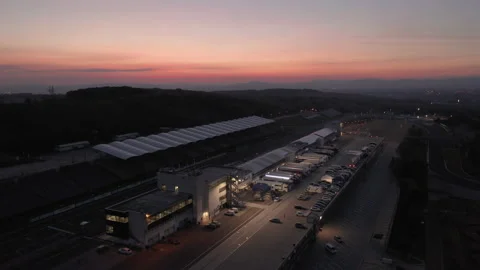 Aerial view of Hungaroring paddock filled with trucks, after sunset Stock Footage 195334983