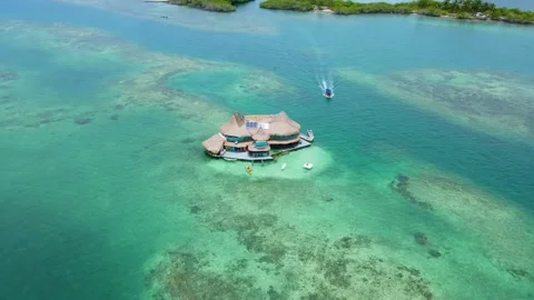 Aerial view of a hut on clear blue water Stock Footage 329596338