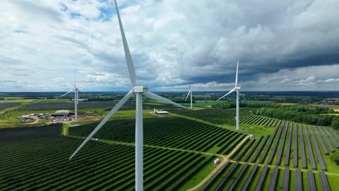 Aerial view of hybrid wind and solar farm in rural England Stock Footage 338391002