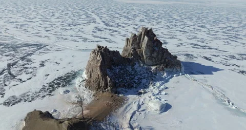 Aerial View of Ice Cracks and Shaman Rock on Lake Baikal Stock-Footage 332389523