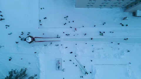 Aerial view of a Ice Slides on Square of City with crowd, ice sculpture, evening Stock Footage 194340587