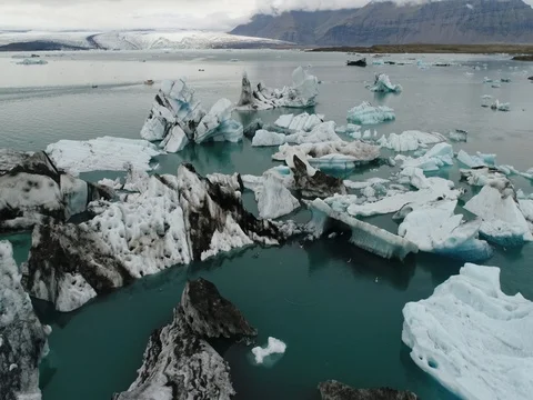 Aerial view of icebergs and formations in Jokulsarlon Glacier Lagoon river Stock Footage