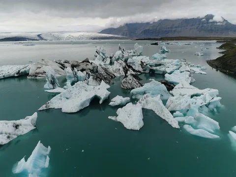 Aerial view of icebergs and formations in Jokulsarlon Glacier Lagoon river Stock Footage