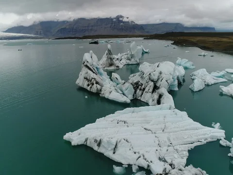 Aerial view of icebergs and formations in Jokulsarlon Glacier Lagoon river Stock Footage