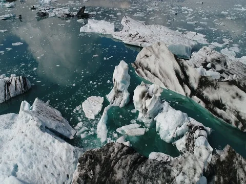 Aerial view of icebergs and formations in Jokulsarlon Glacier Lagoon river Stock Footage