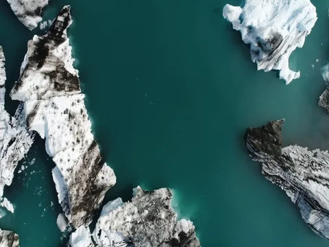 Aerial view of icebergs and formations in Jokulsarlon Glacier Lagoon river Stock Footage