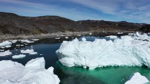 Aerial view. Icebergs float in the blue water of a remote Greenland fjord  Stock Footage 328971069