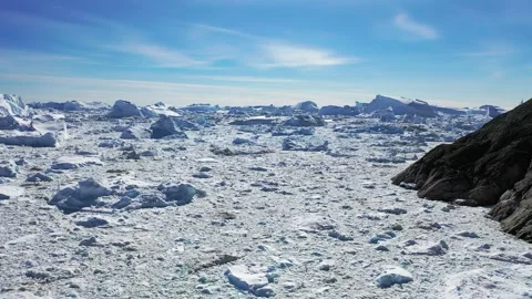 Aerial view. Icebergs float in the blue water of a remote Greenland fjord  Stock Footage 328971078