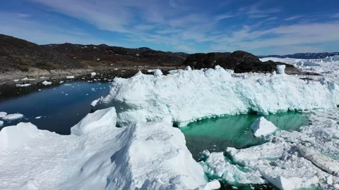 Aerial view. Icebergs float in the blue water of a remote Greenland fjord  Stock Footage 328971089
