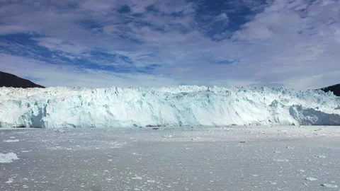 Aerial view. Icebergs float in the blue water of a remote Greenland fjord  Stock Footage 328971096