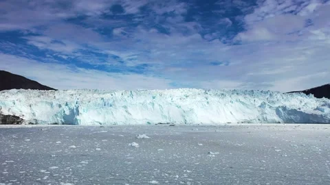 Aerial view. Icebergs float in the blue water of a remote Greenland fjord  Stock Footage 328971097