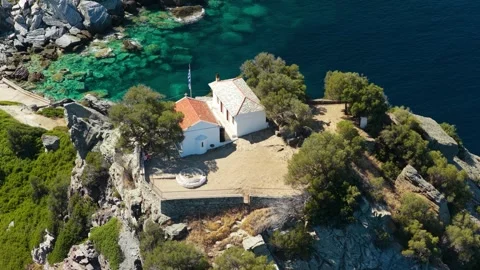 Aerial view of the iconic Agios Ioannis church perched on a rocky cliff above Stock Footage 346681730