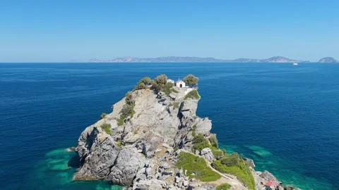 Aerial view of the iconic Agios Ioannis church perched on a dramatic rocky Stock Footage 346692448