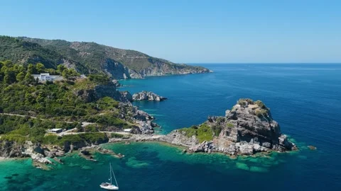 Aerial view of the iconic Agios Ioannis Church perched on a rocky outcrop above Stock Footage 346704342