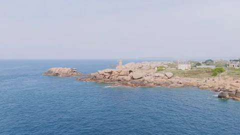 Aerial view of the iconic Phare de Mean Ruz lighthouse perched on the dramatic Stock Footage 346672390