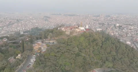 Aerial View of the Iconic Stupa Surrounded by Prayer Flags and Monkeys Stock Footage 319477062